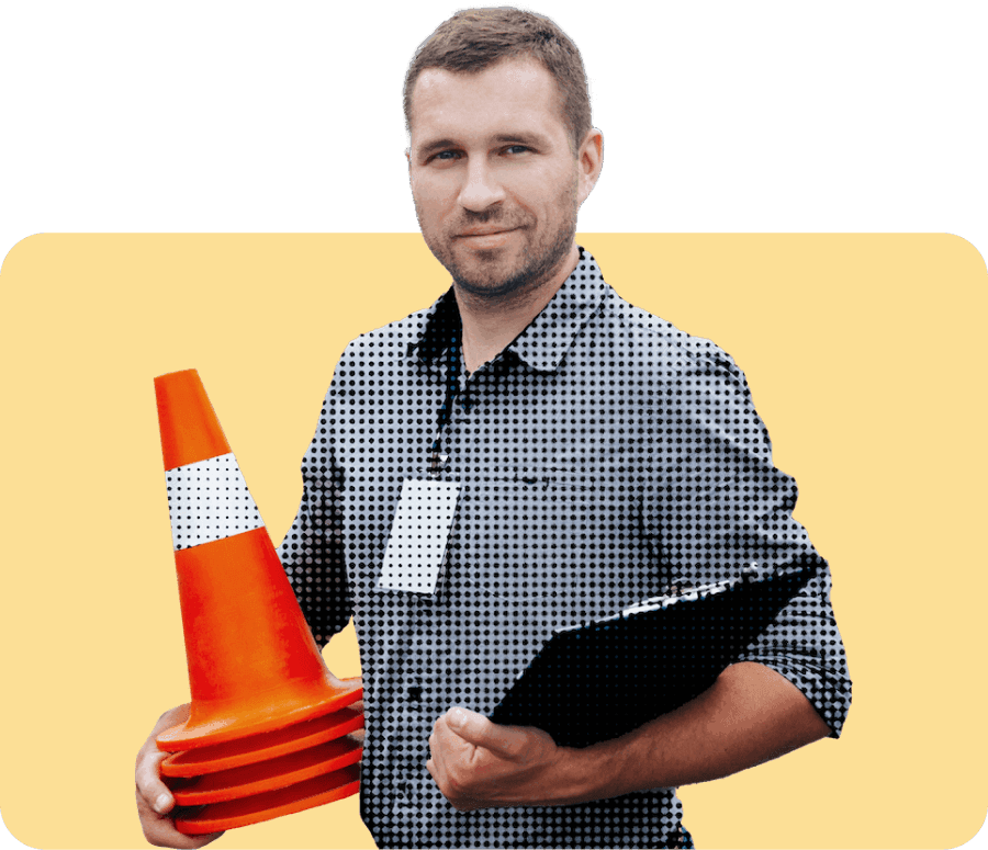 Man holding clipboard and traffic cones