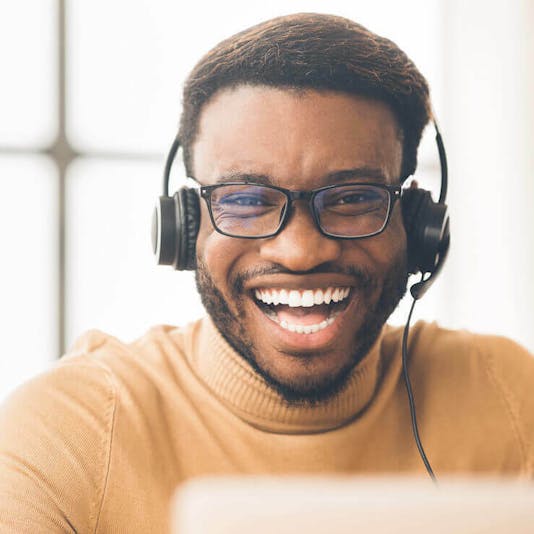 man with headphones laughing