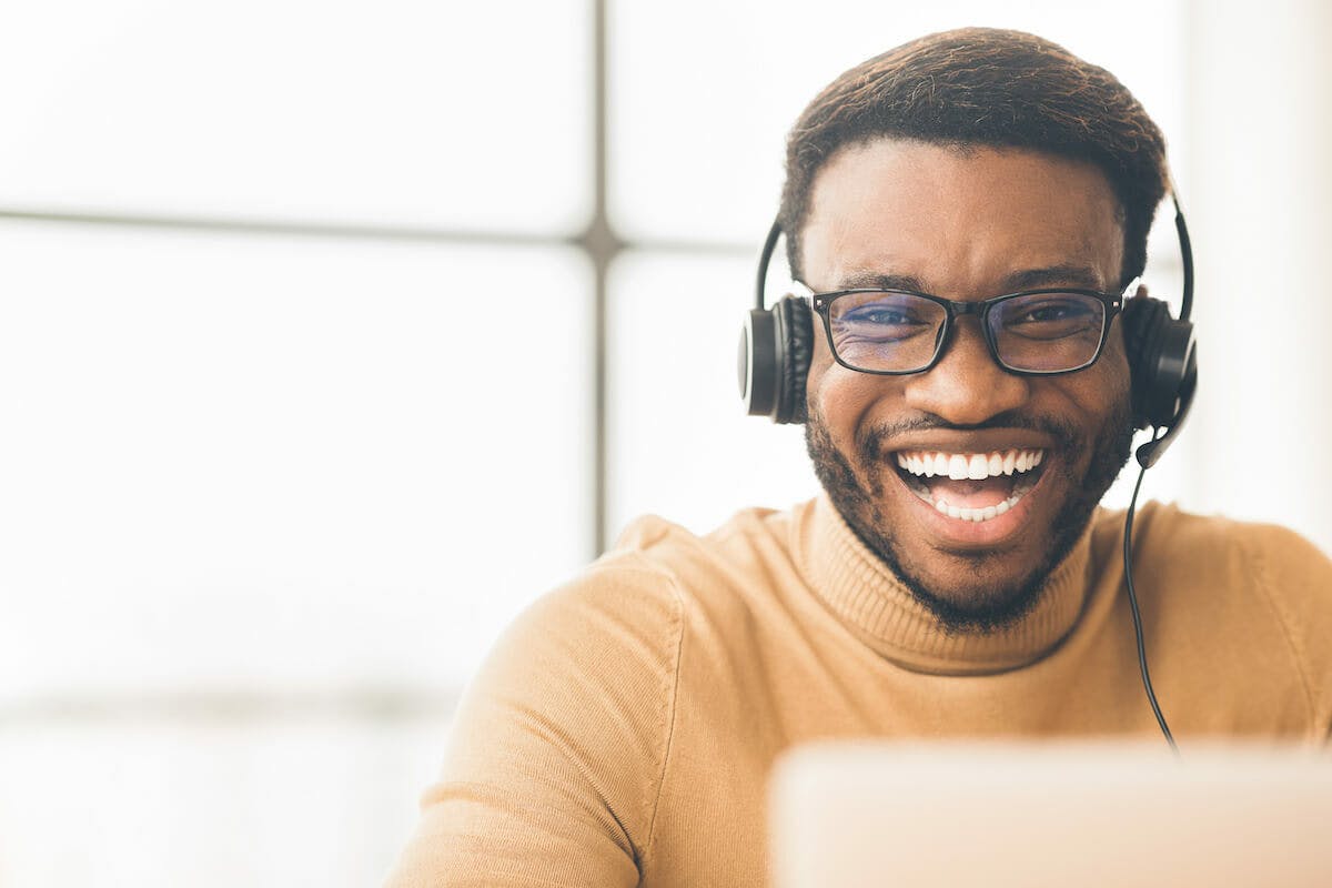 man with headphones laughing