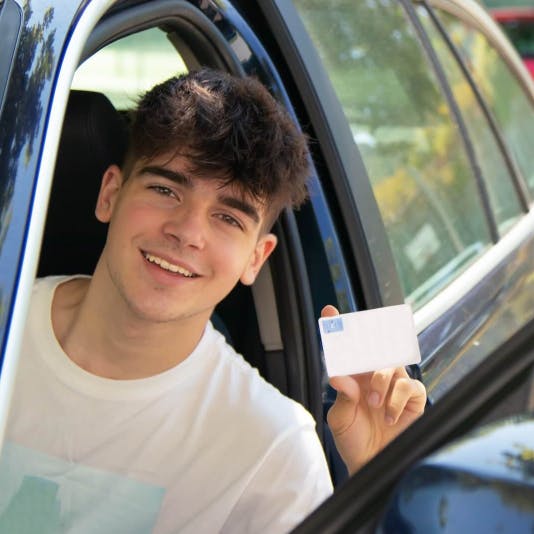 Boy holding drivers license