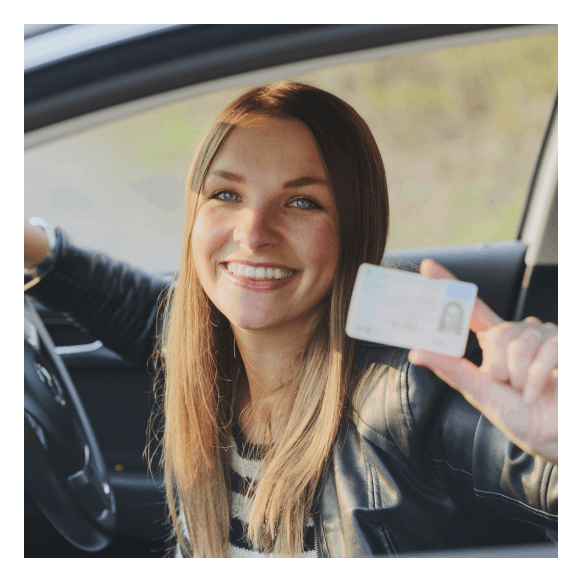 Smiling woman holding a driver's license