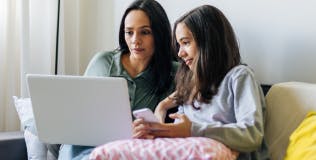 Mother and daughter looking at a laptop