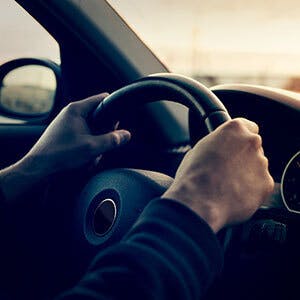 Man driving behind the wheel