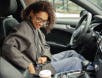 Woman buckling seat belt in a car