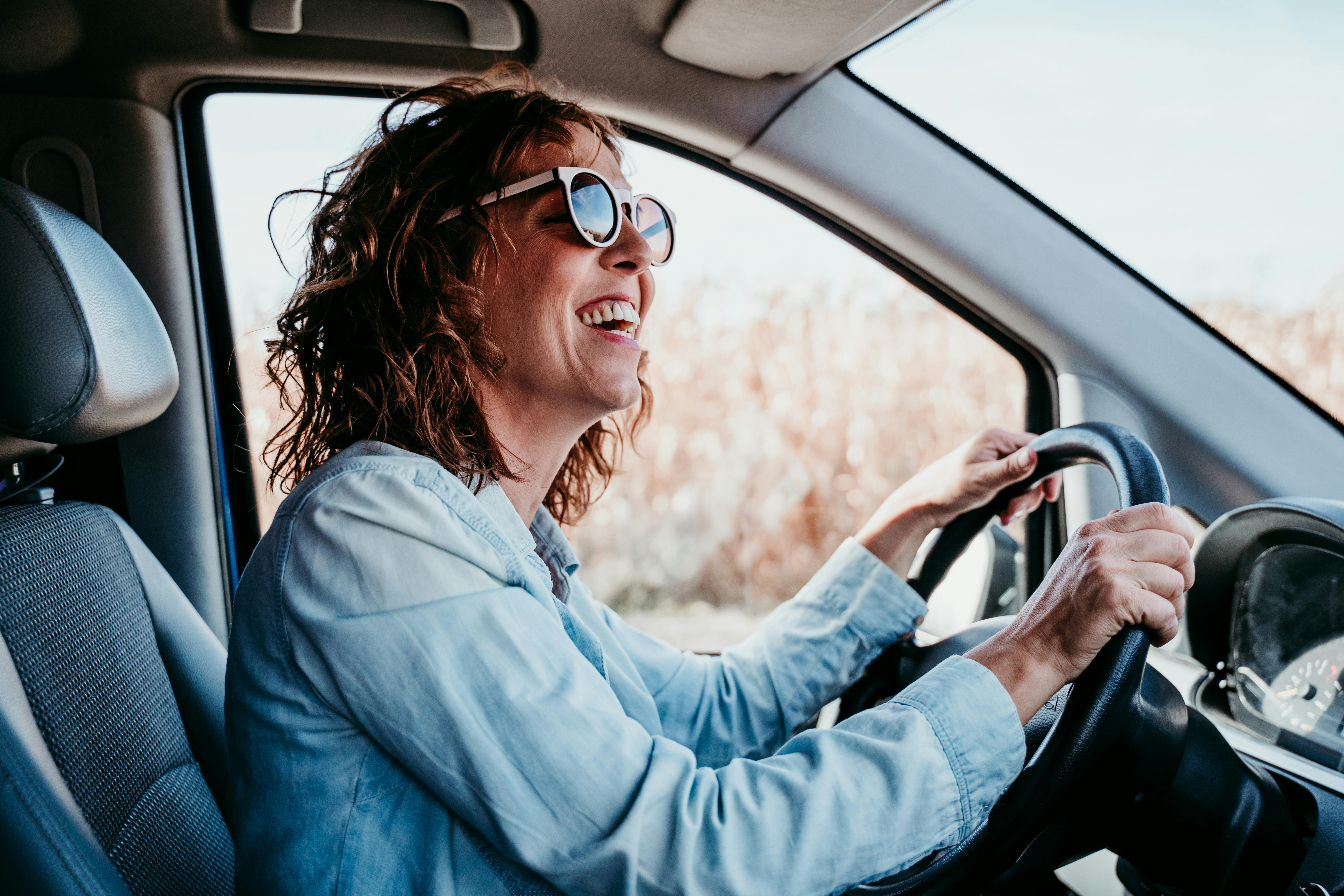Happy woman driving a vehicle
