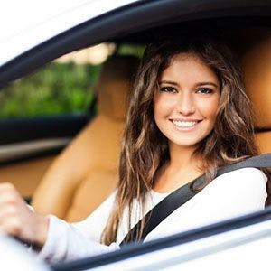 Aceable driver smiling out the window of her car