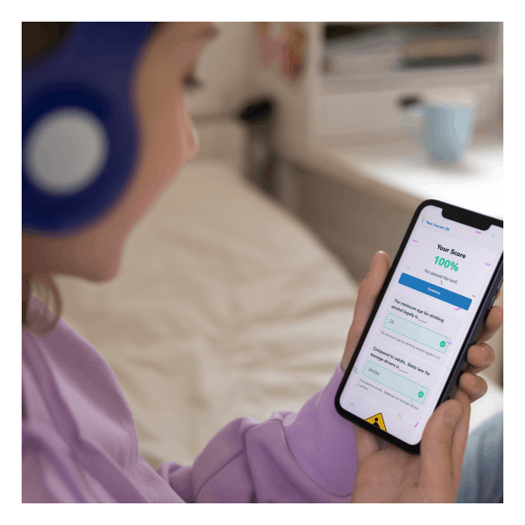 Girl looking at a mobile phone with course test results on the screen