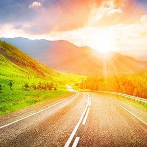 A country road going towards the mountains