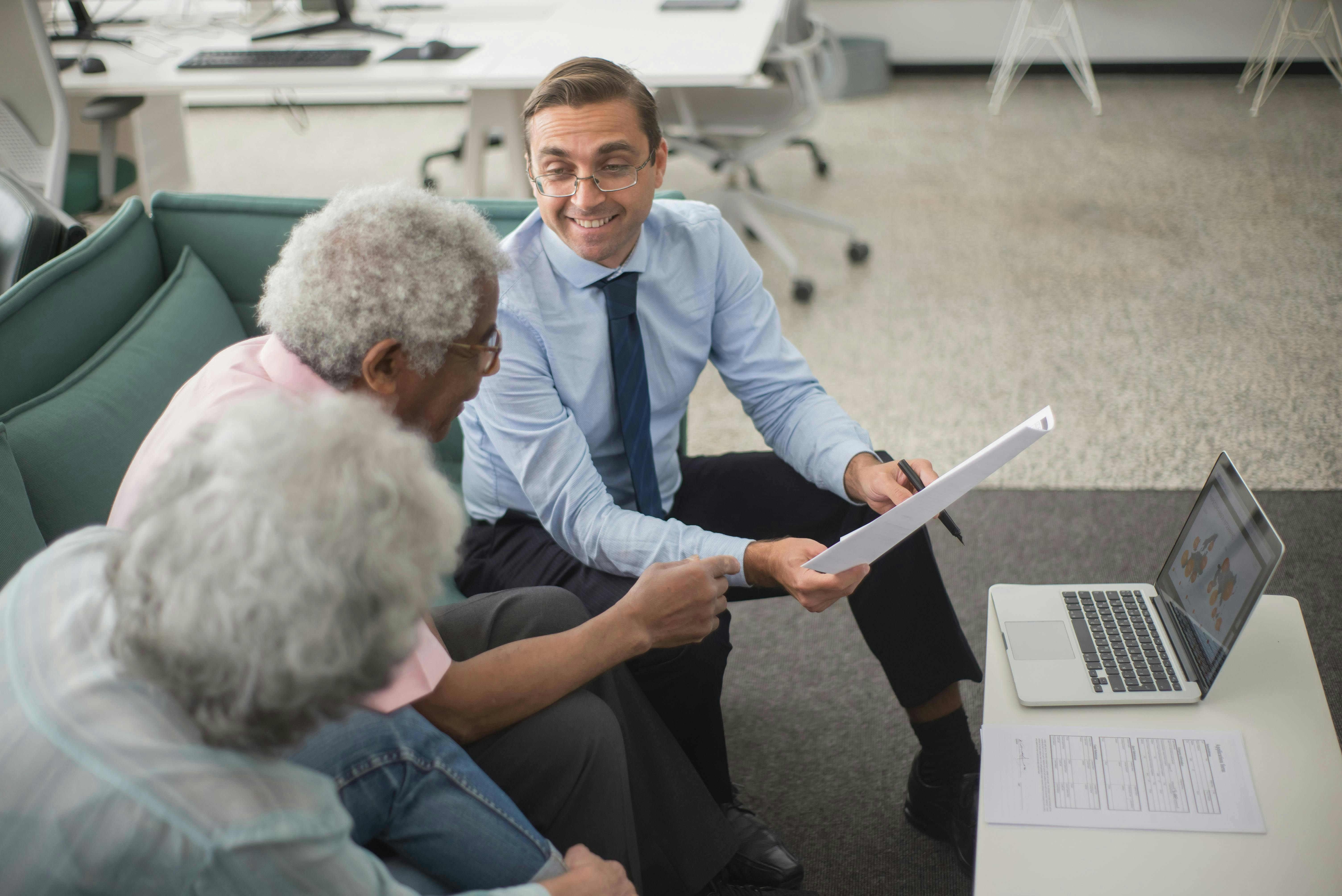 Insurance Agent talking with a couple in an office