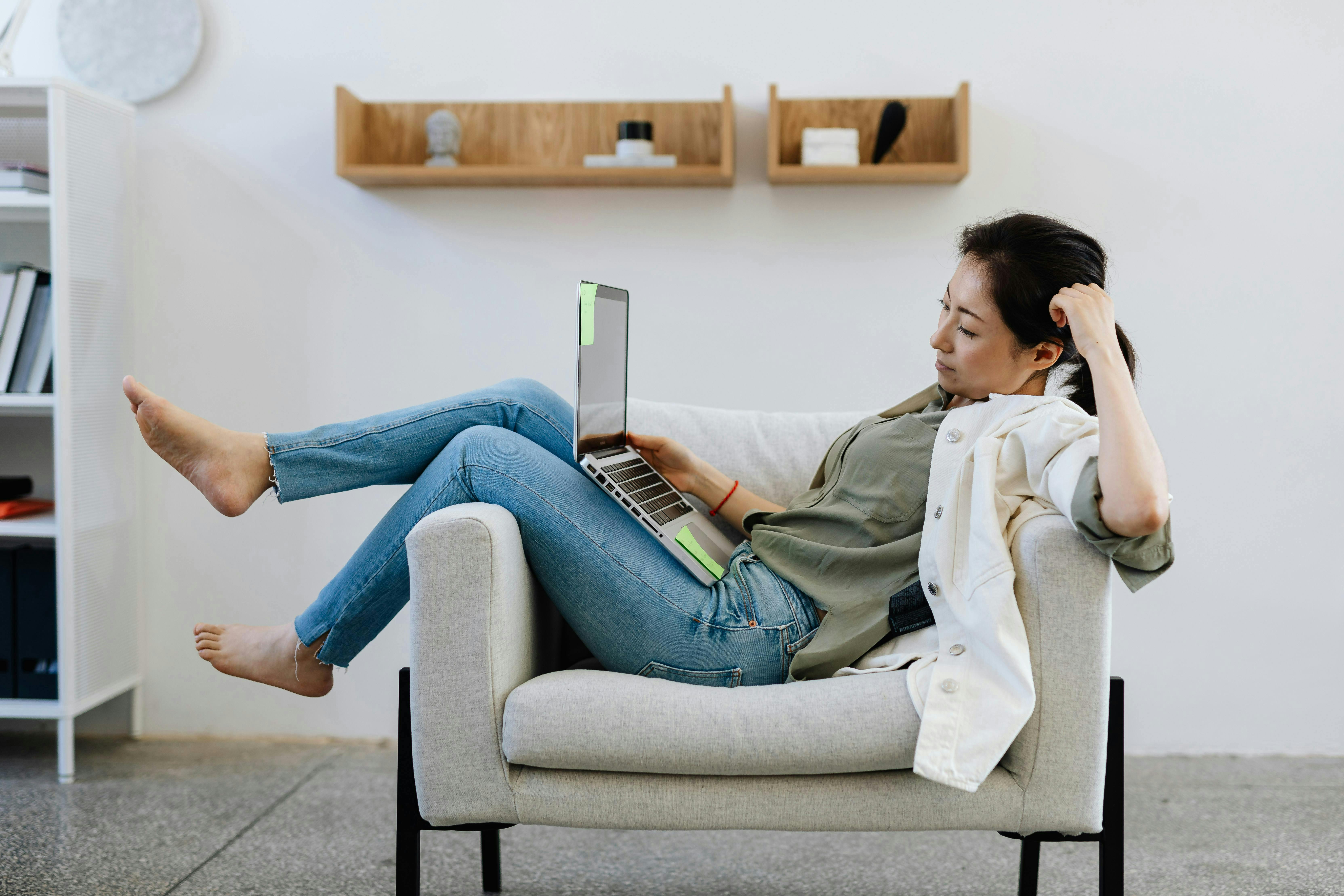 woman working remote while on the couch
