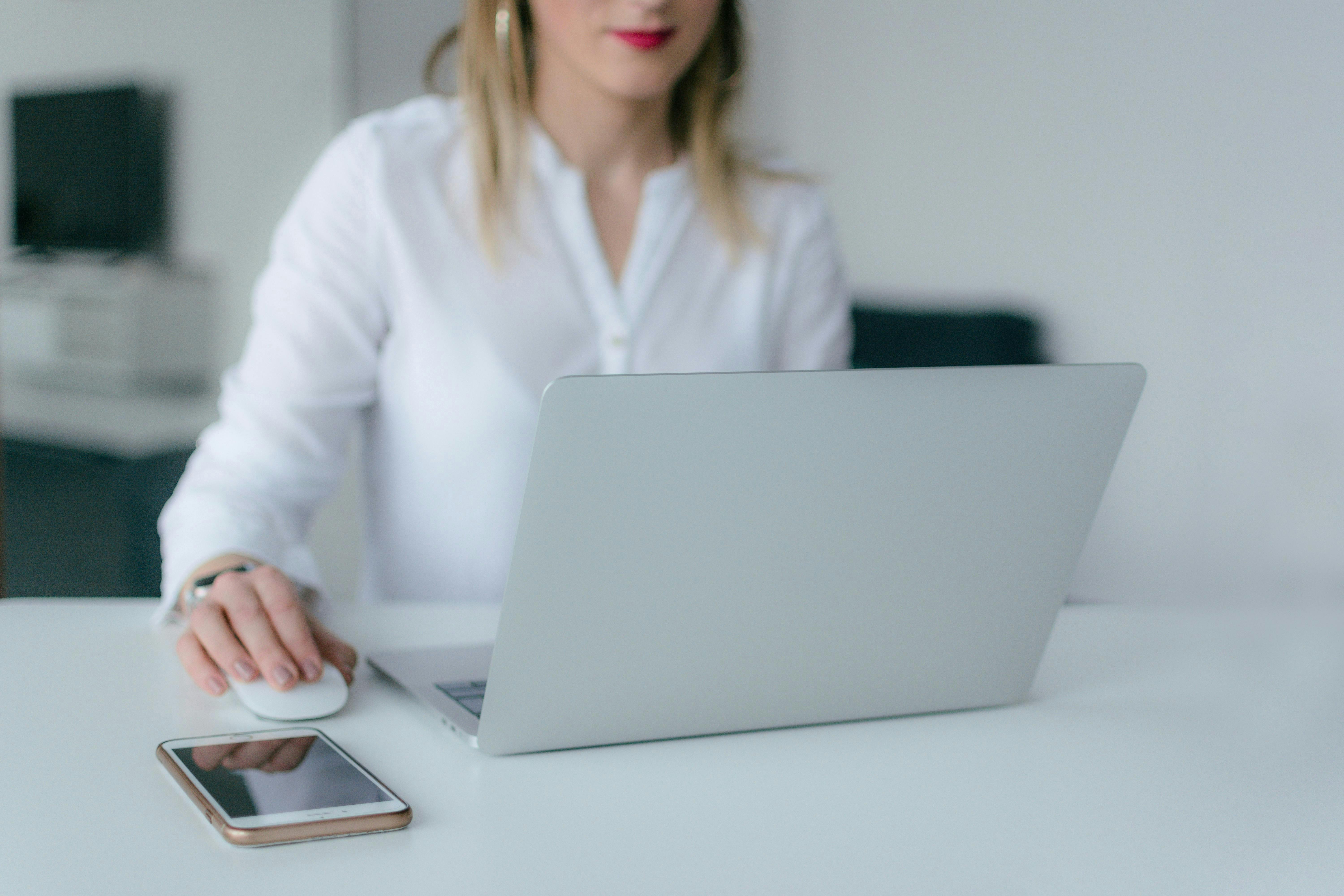 woman on computer wearing a white top