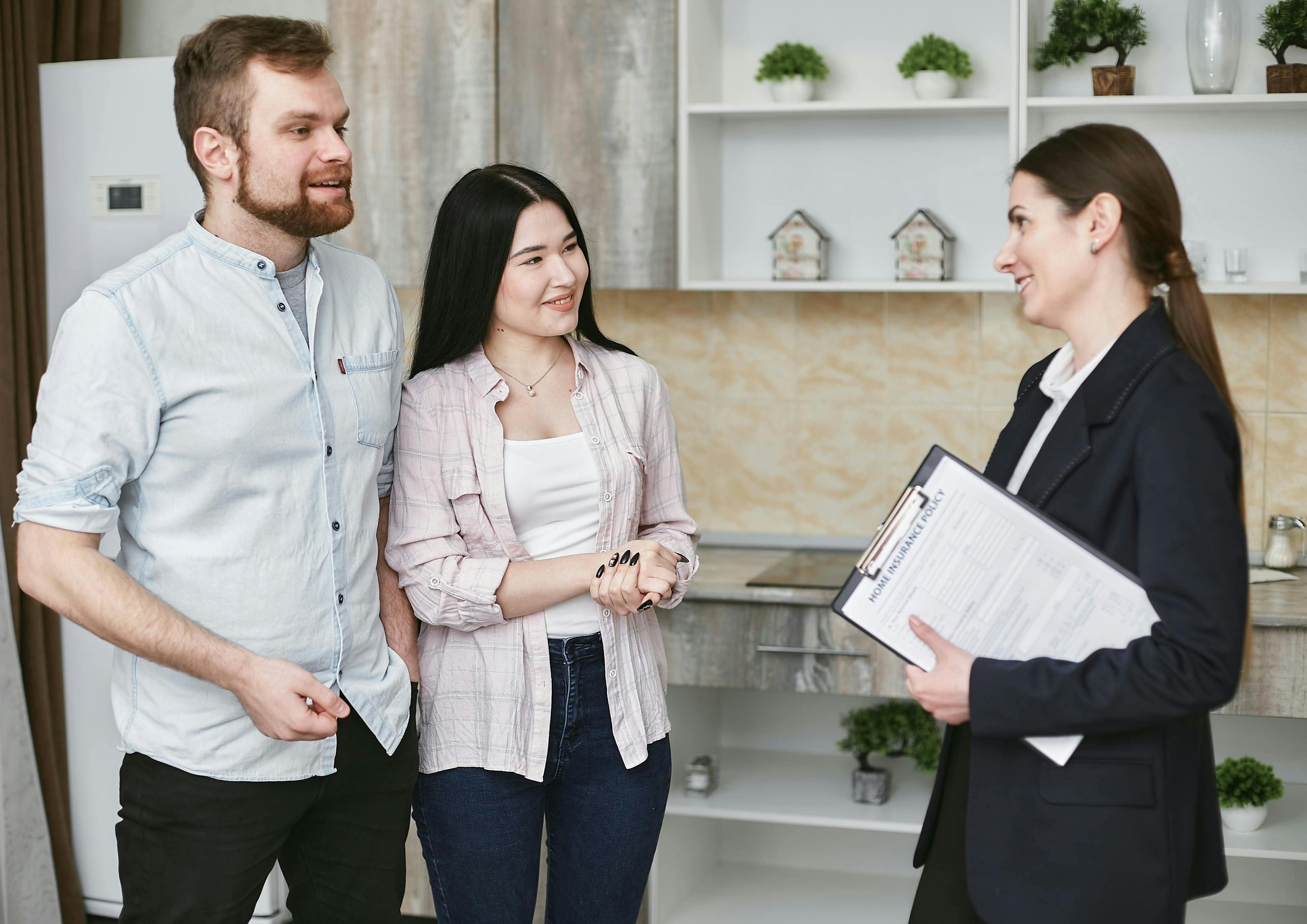 Insurance agent meeting with two clients in an office