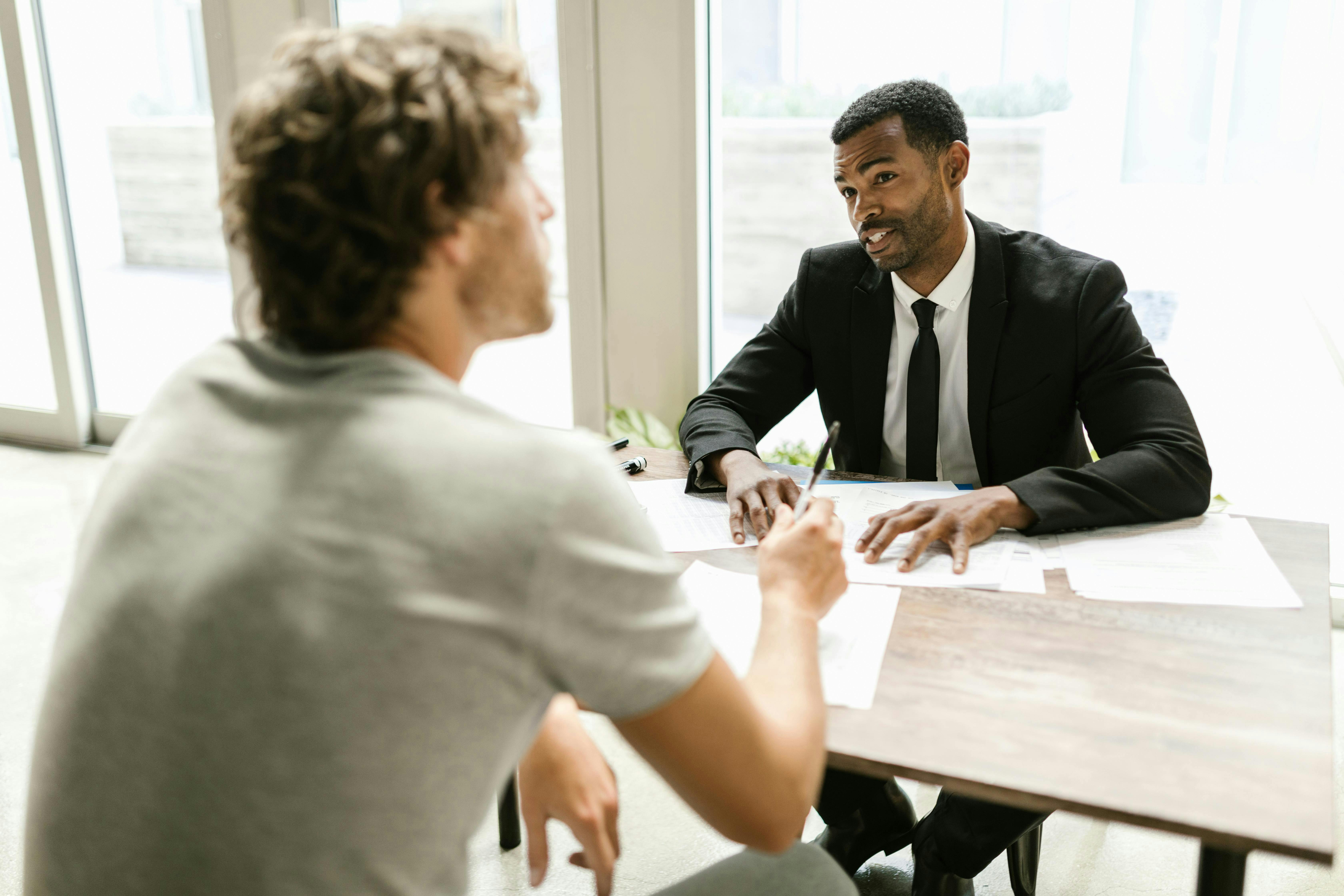 Insurance agent going over paperwork with a client in his office