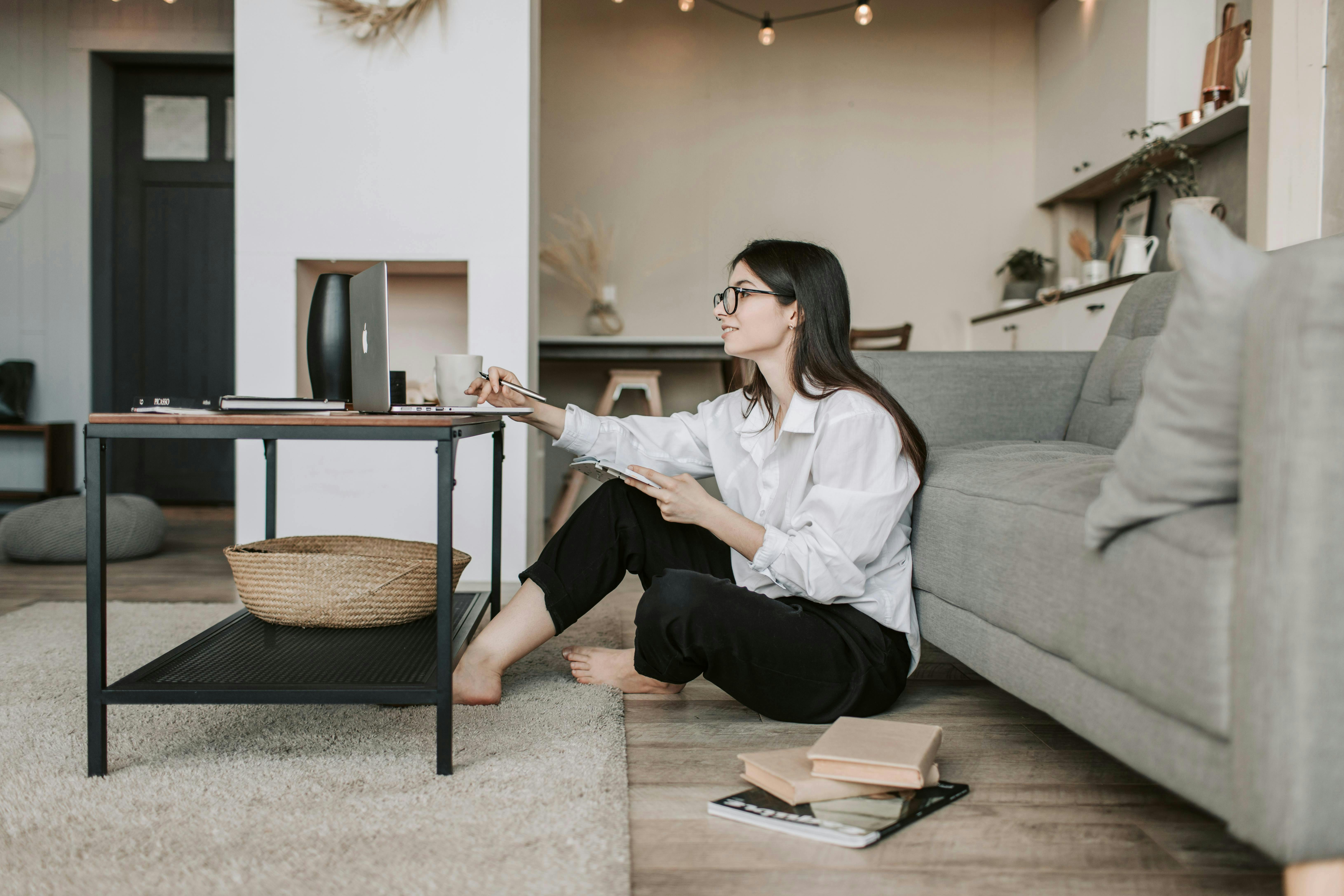 woman sitting on ground at her computer
