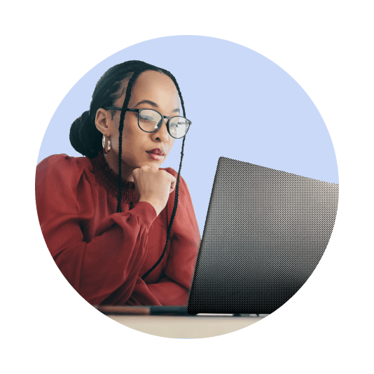 Woman in glasses studying a laptop