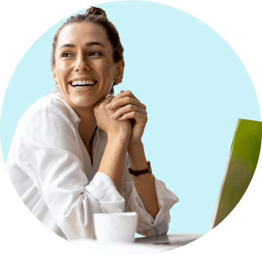 woman smiling looking off into the distance with coffee