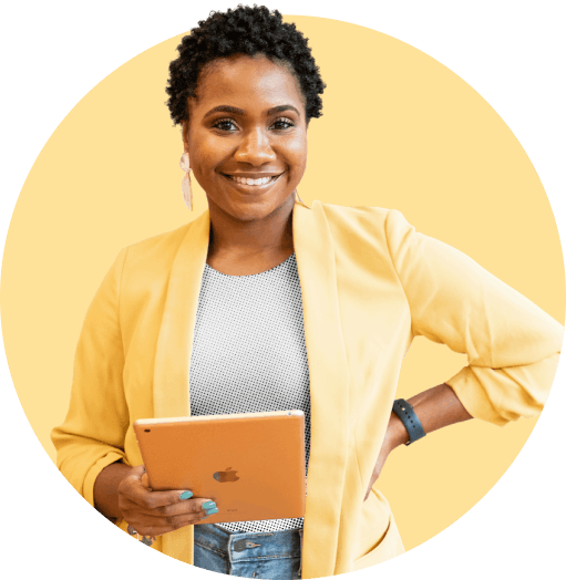 Women holding iPad, smiling, yellow backdrop
