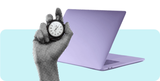 Hand holding stopwatch with laptop in the background