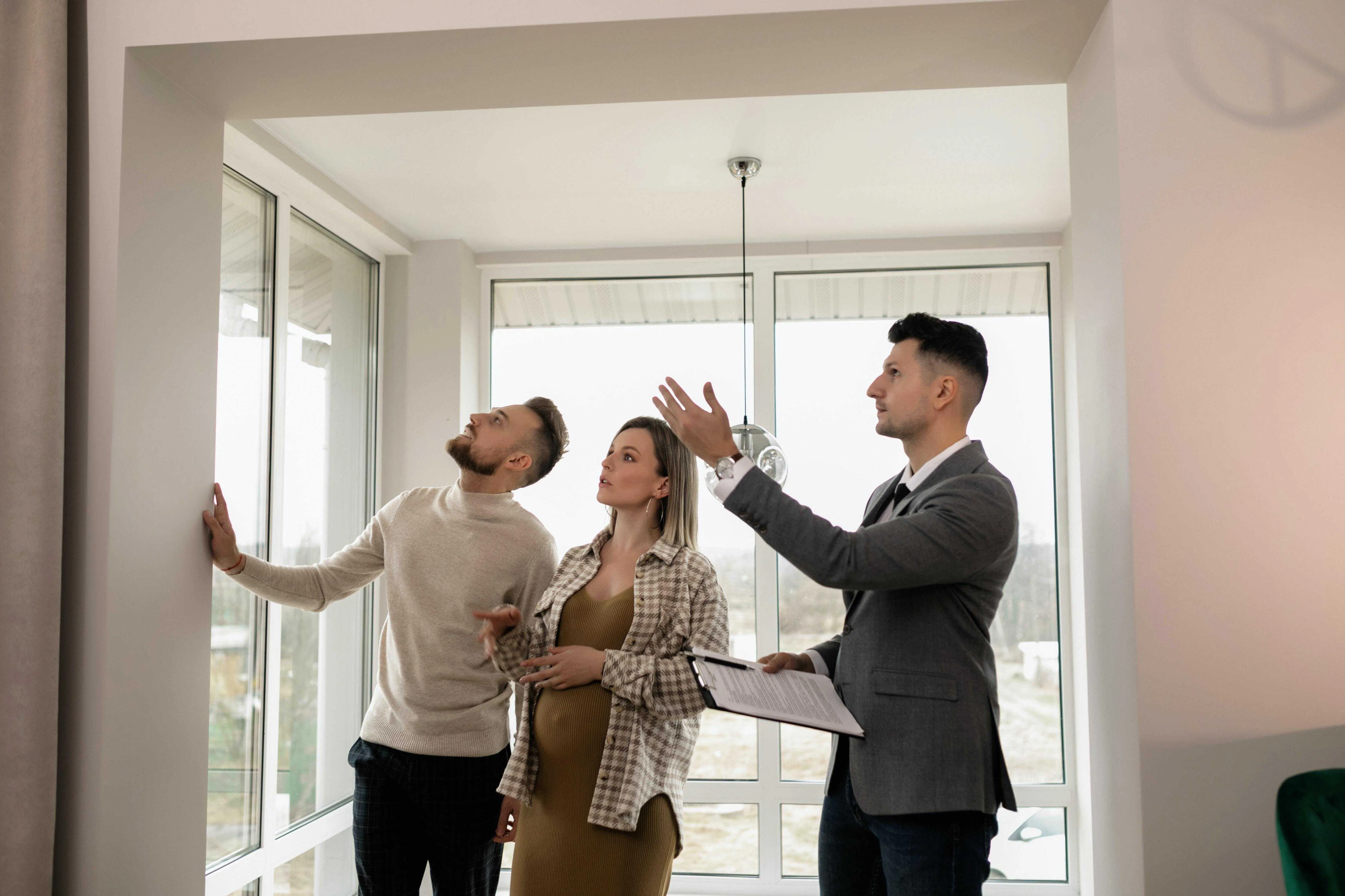 Agent showing a home to a couple